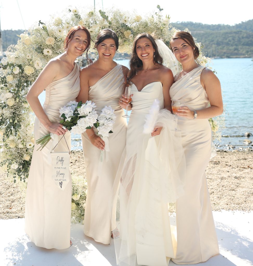 Bride with her bridesmaids who are wearing bridesmaids dresses from Pretty Lavish